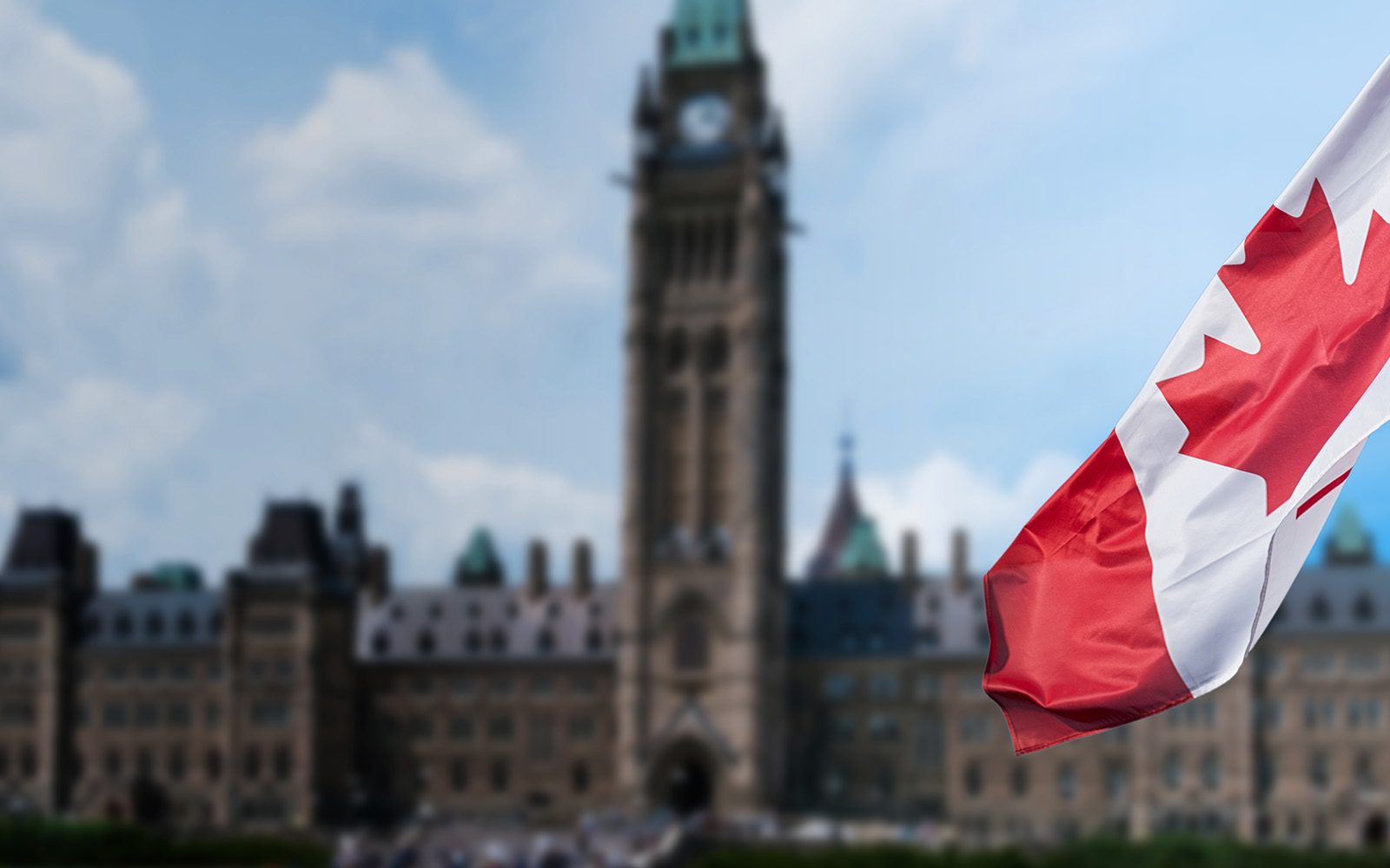 Drapeau canadien flottant devant le Parlement