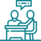 Icon of two workers sitting at a table together and one of them is talking.