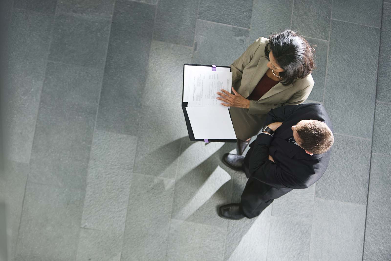 two people reviewing documents in an office setting