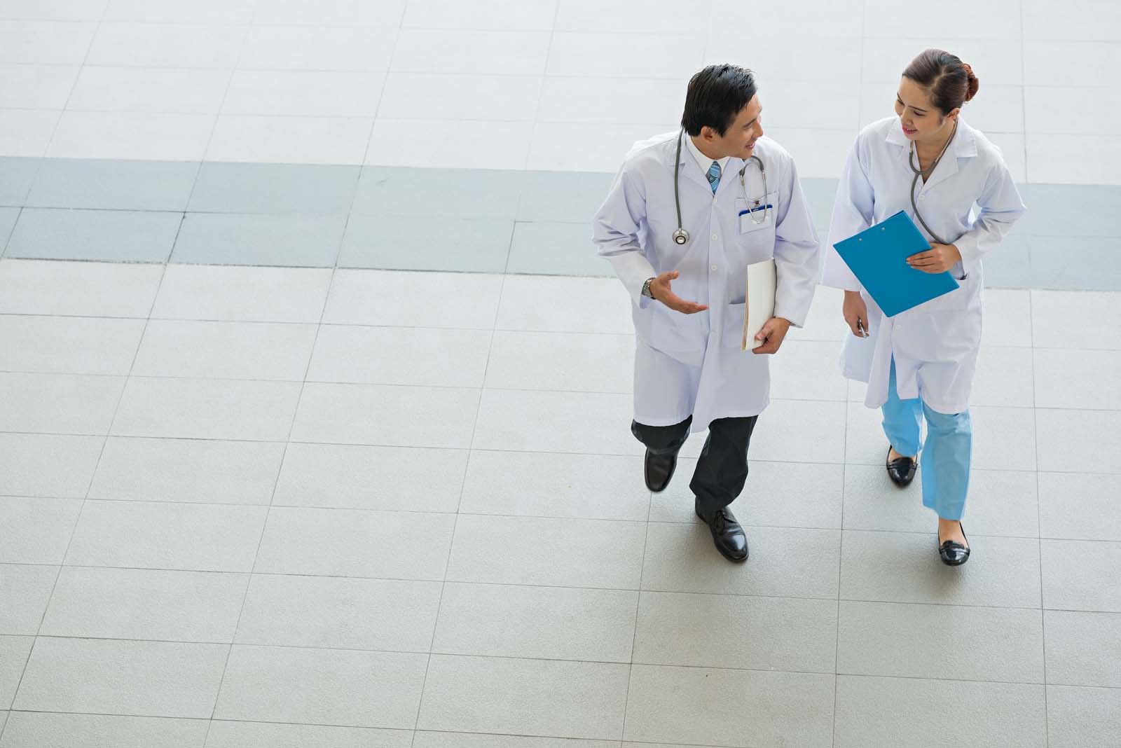 two doctors walking down a corridor 