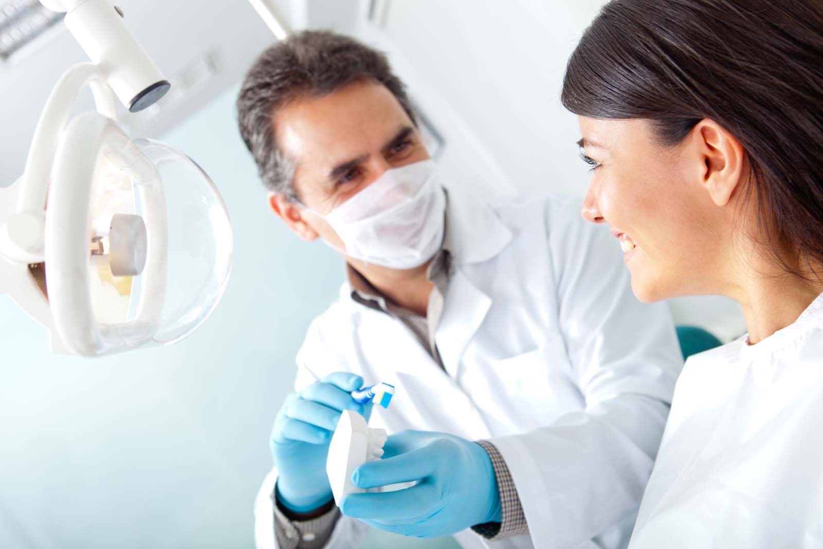 a dentist helping a patient