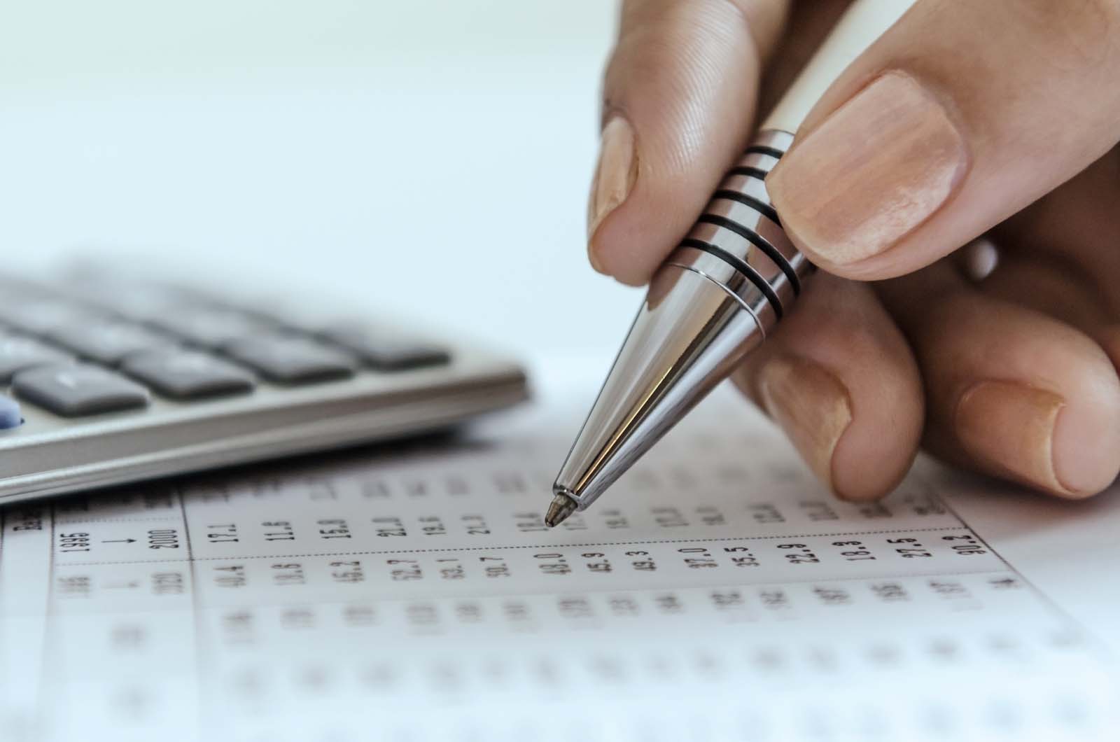 close up of a hand holding a pen