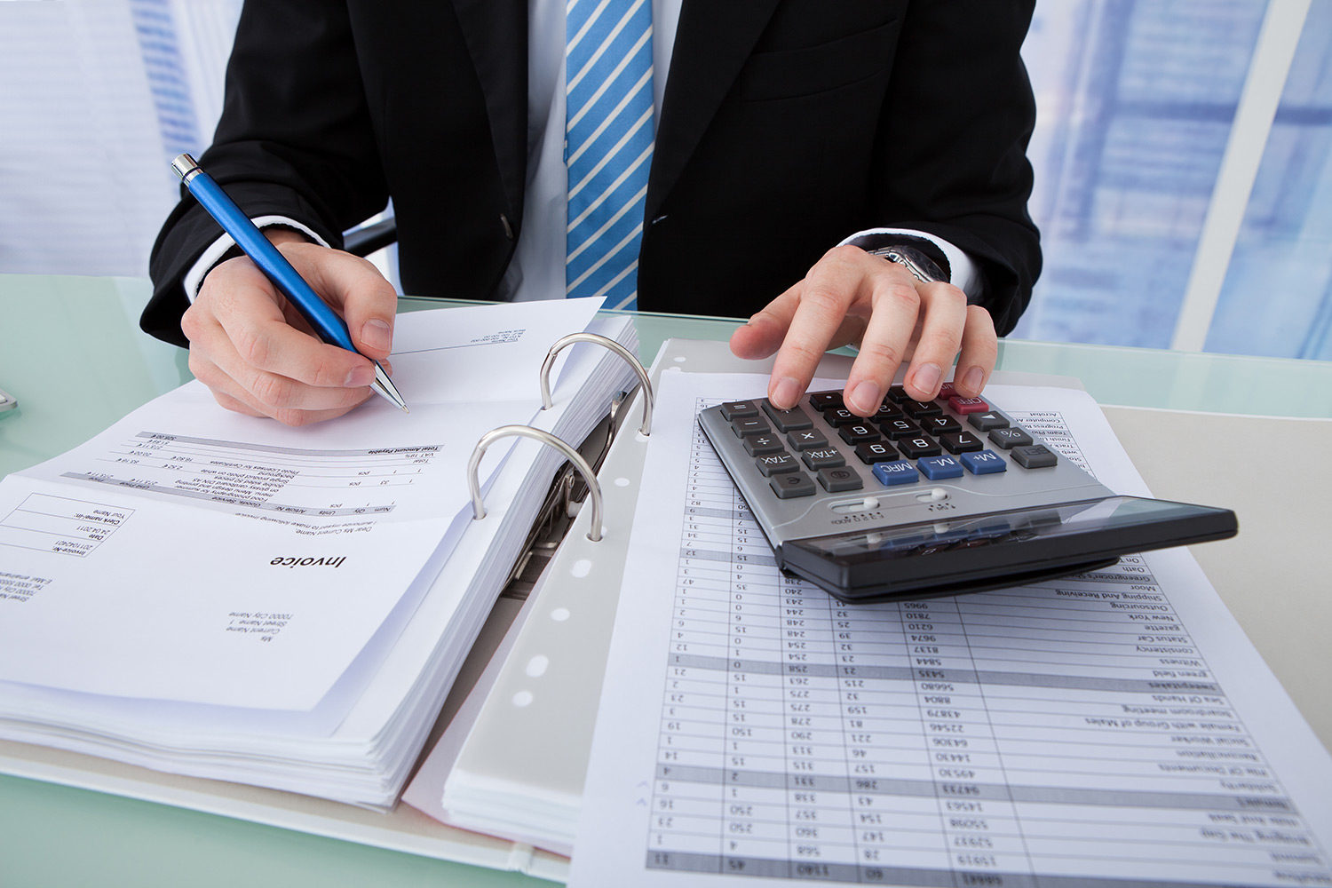 person working on a calculator