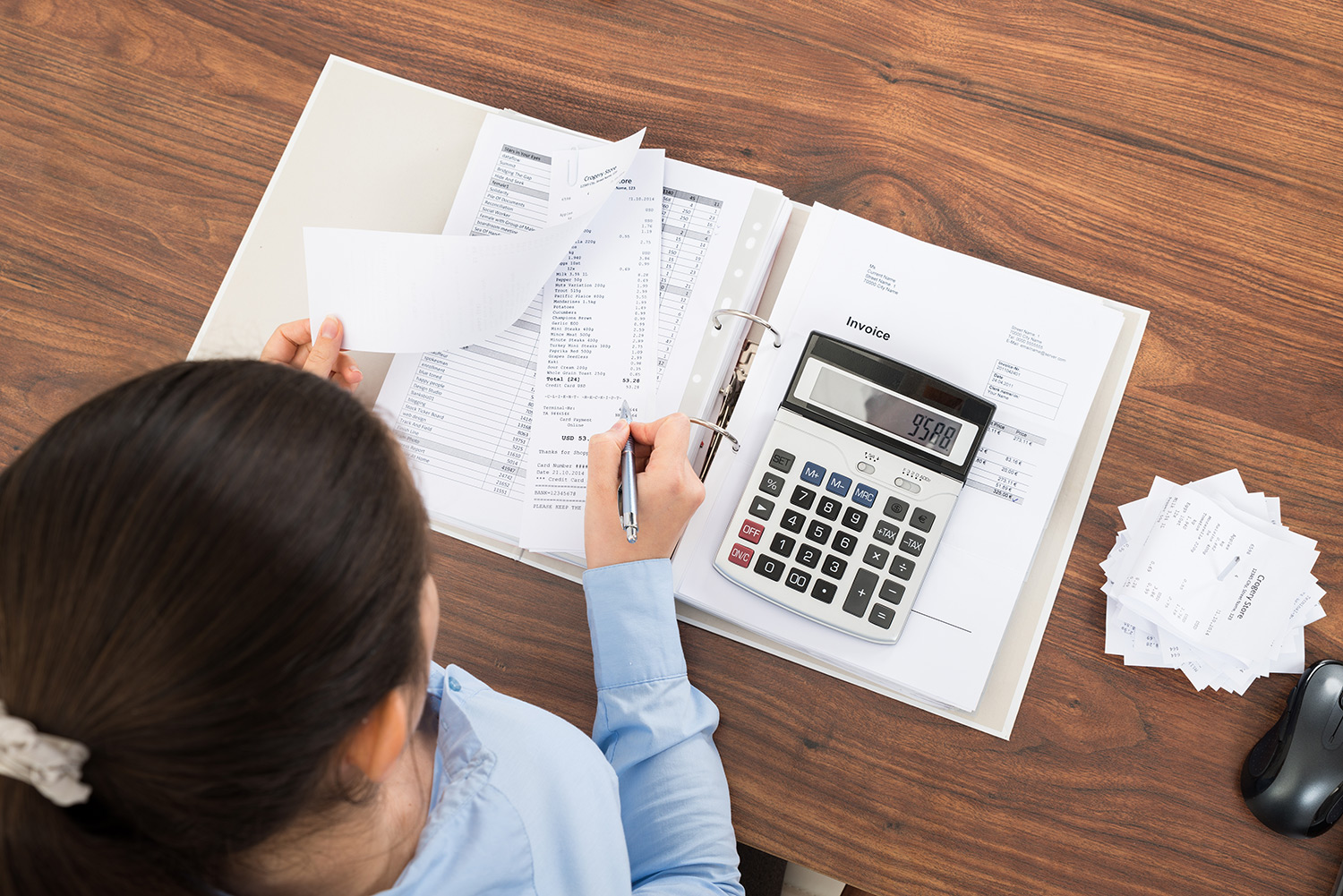 overhead view of a person working on paperwork 