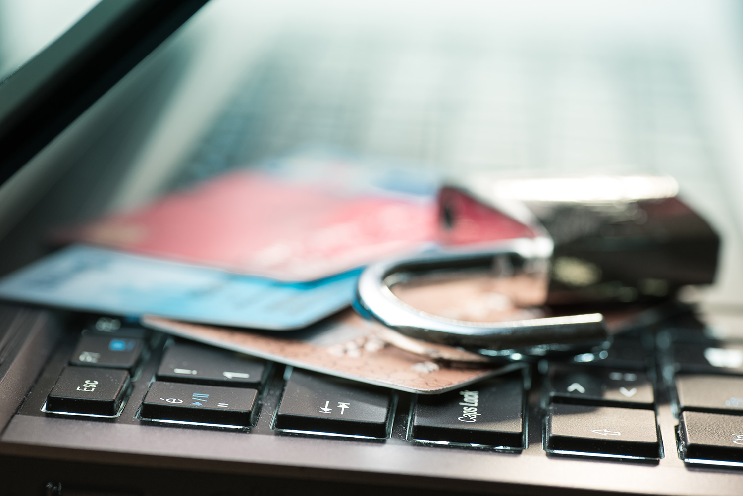 Bank cards sitting on a keyboard with a lock