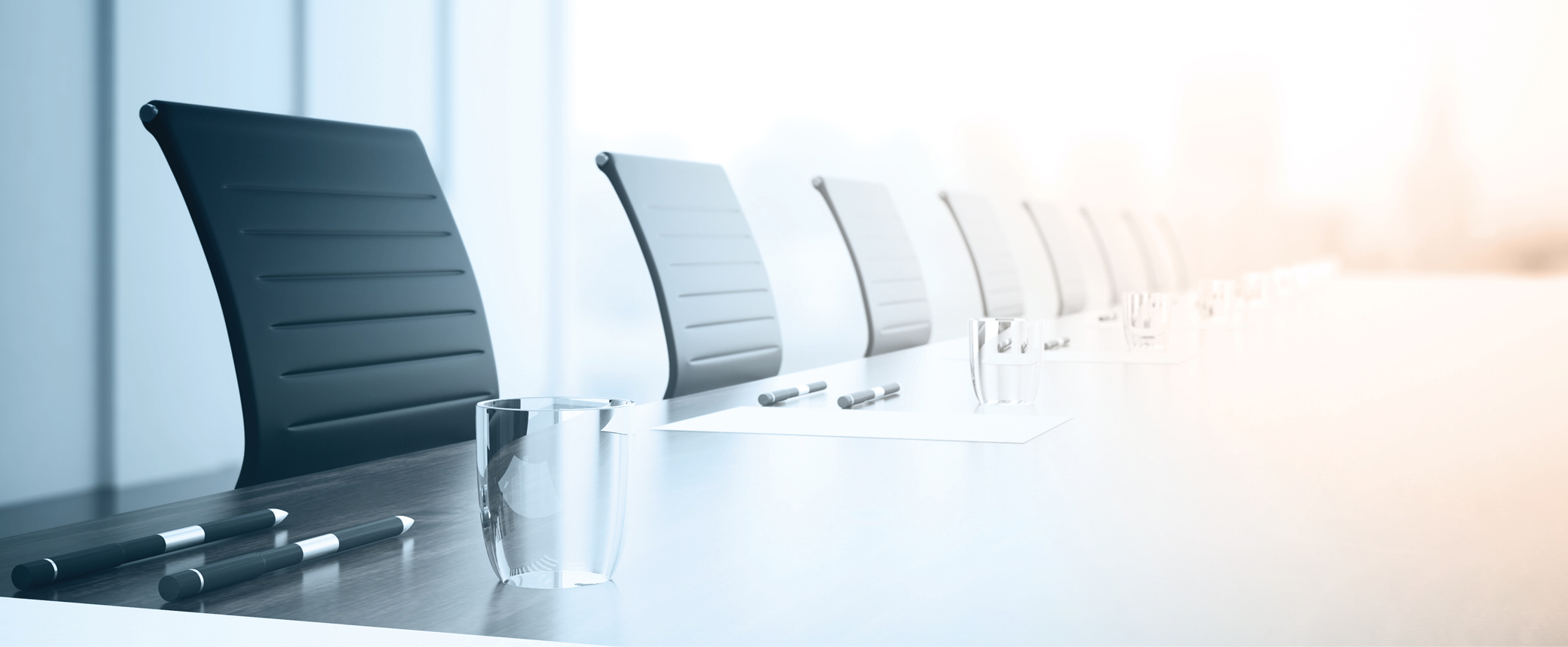 Close up of empty boardroom table with chairs