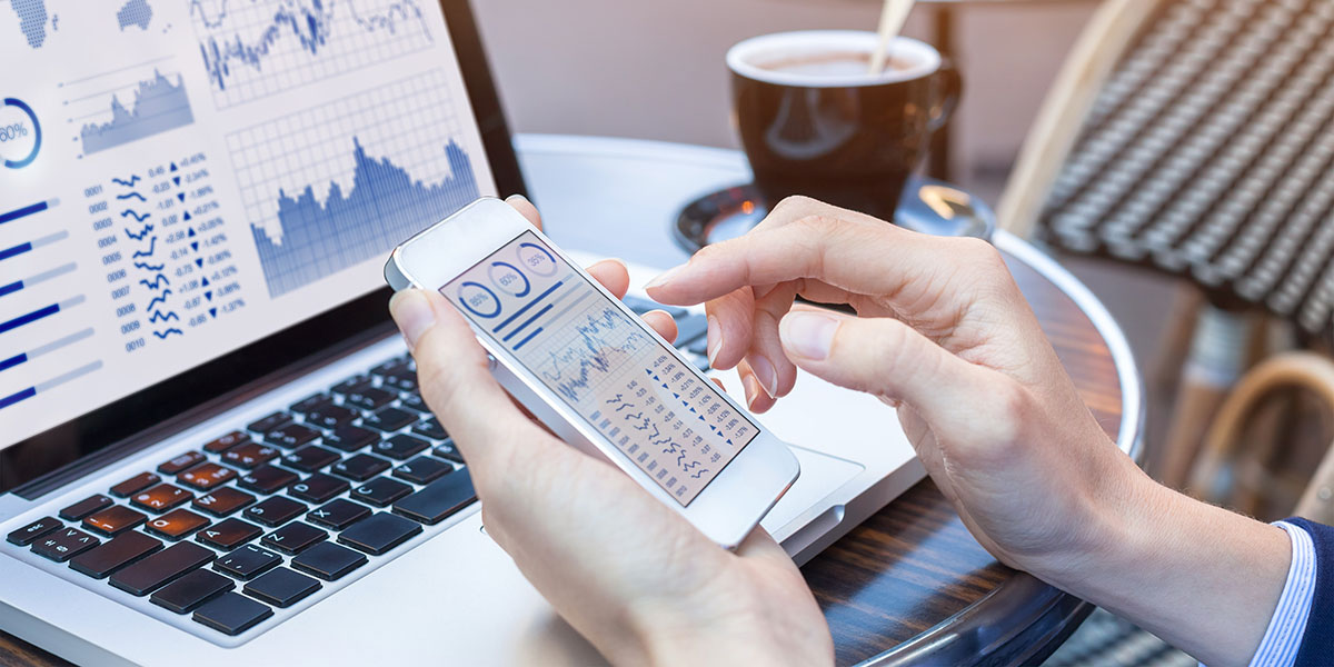 person reviewing analytics on a laptop and cell phone