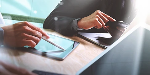 hands of professionals working at table with laptop and phone