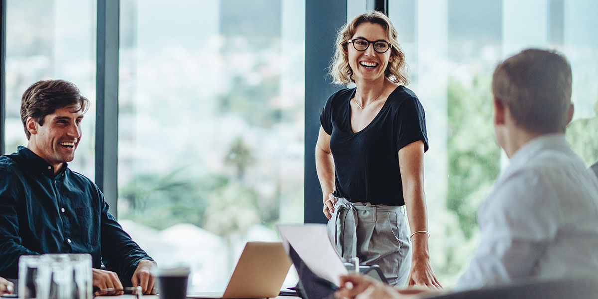 three people having a meeting and laughing