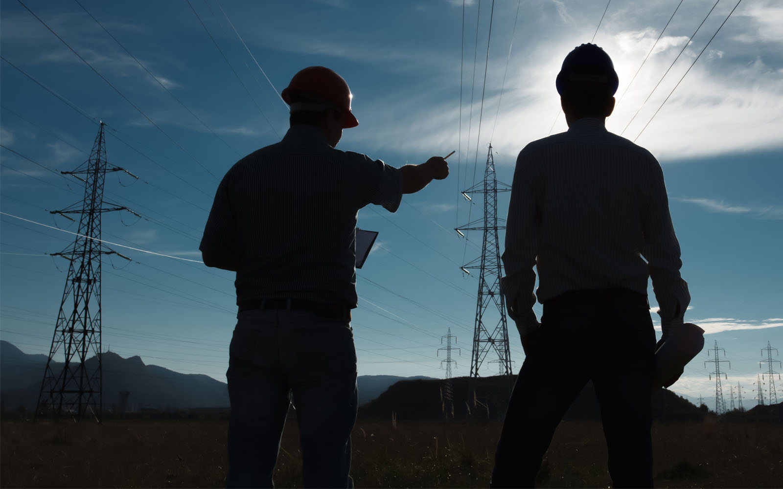 two people overlooking power lines