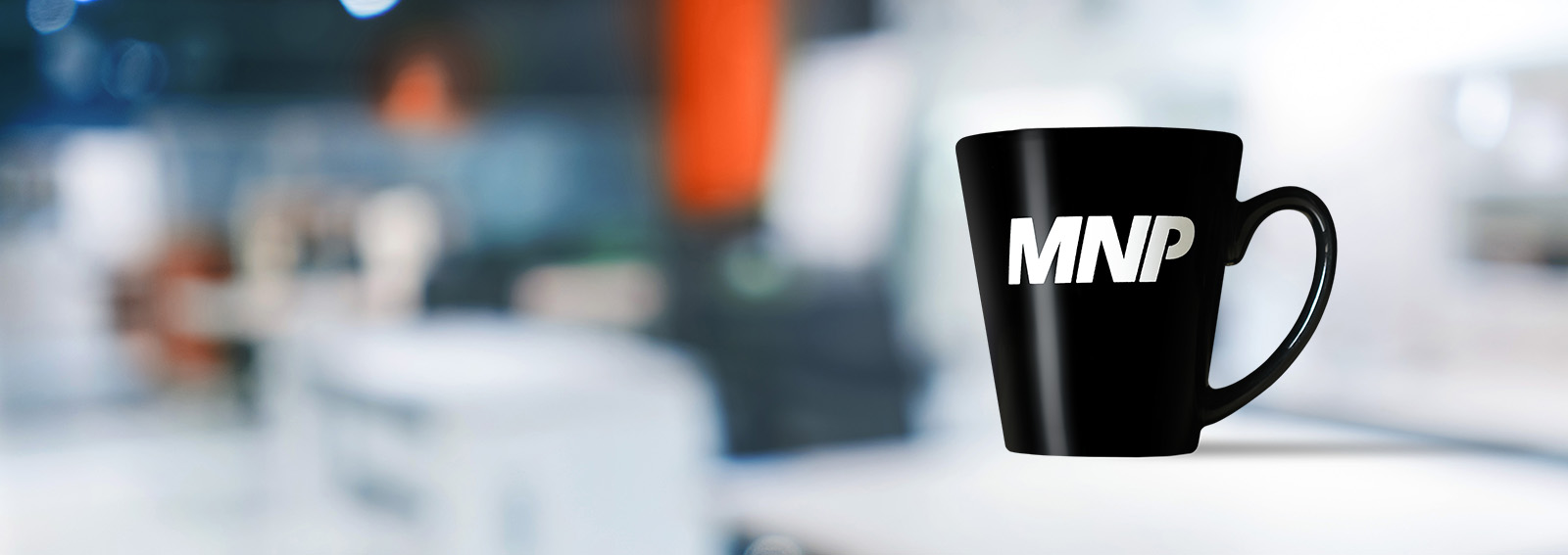 Black MNP mug on a blurred countertop