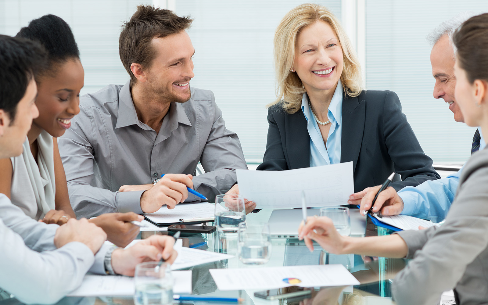 Group Of Happy Coworkers Discussing In Conference