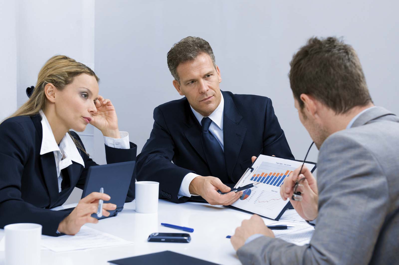 three people in a meeting 