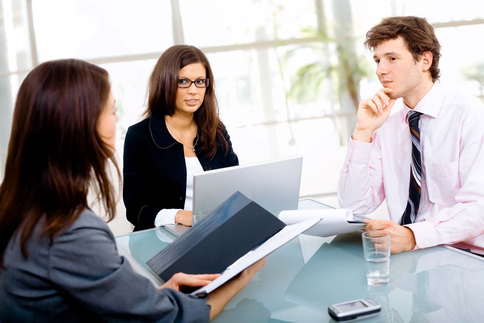 three people in a meeting