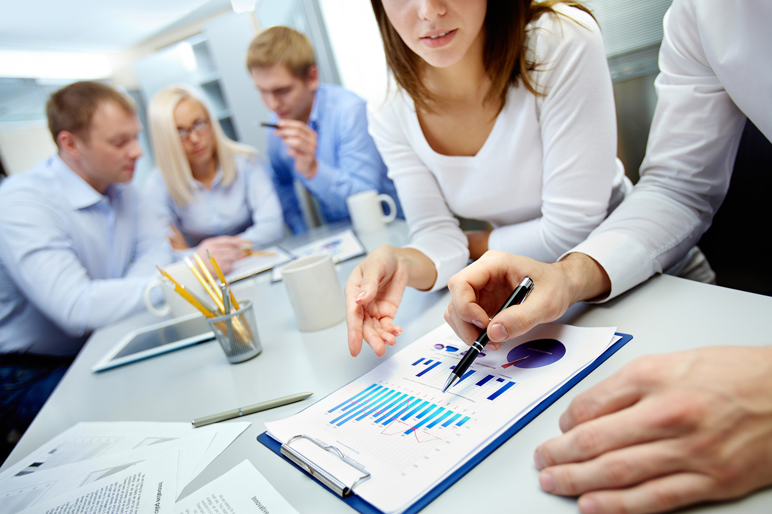 group of people reviewing a chart