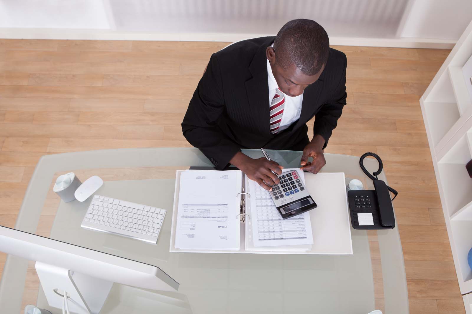 business person working with documents and a calculator