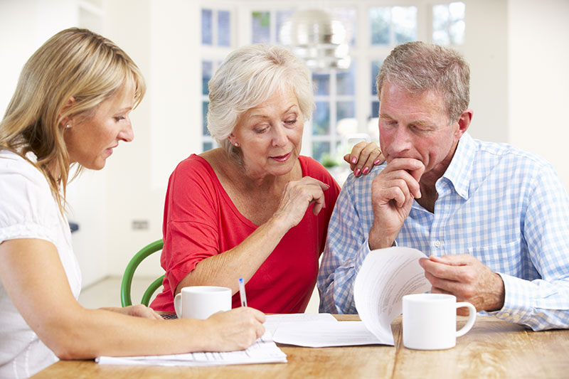 group of people working together reviewing documents