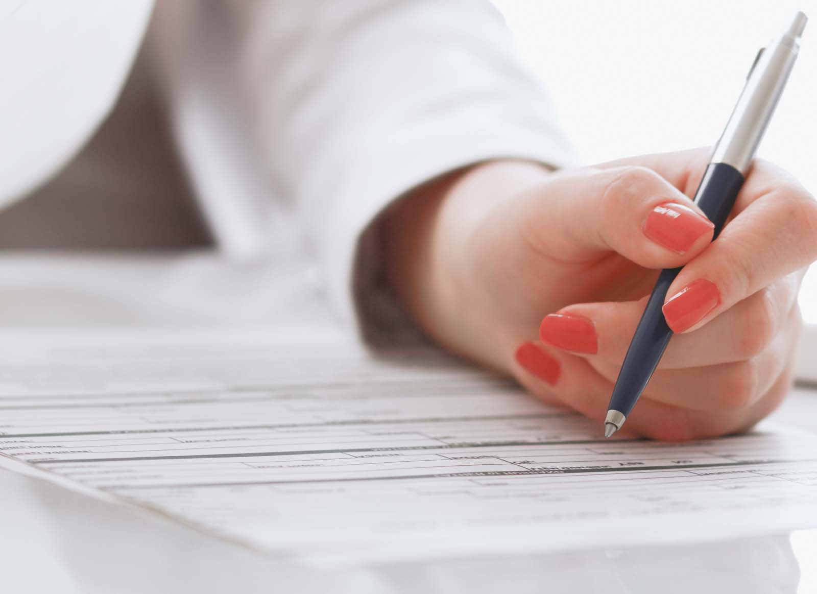 close up of someone's hand holding a pen