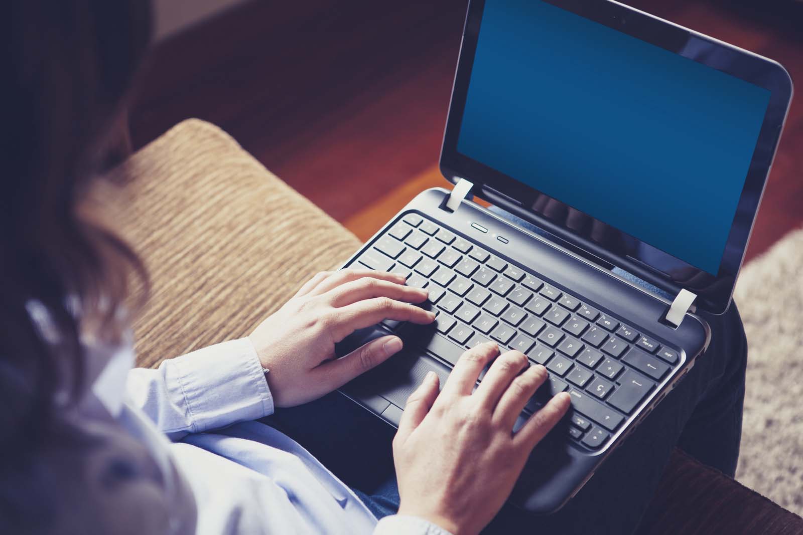 person typing on a laptop