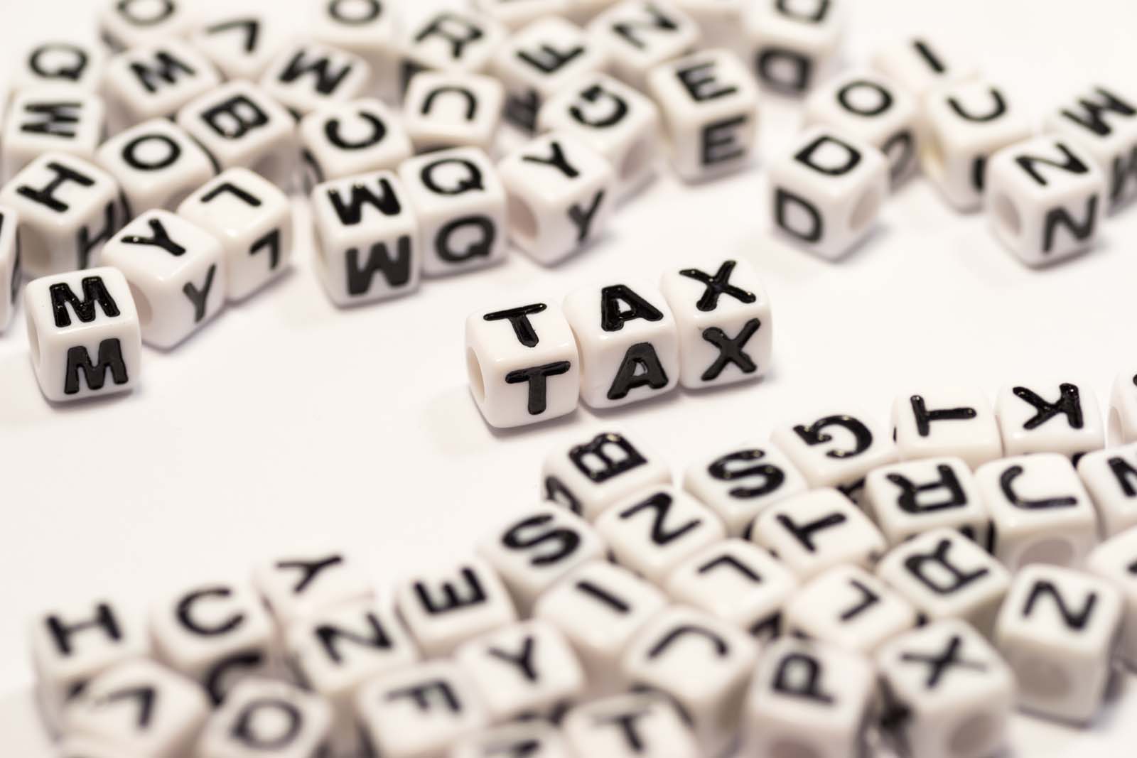 alphabet dice spelling out tax