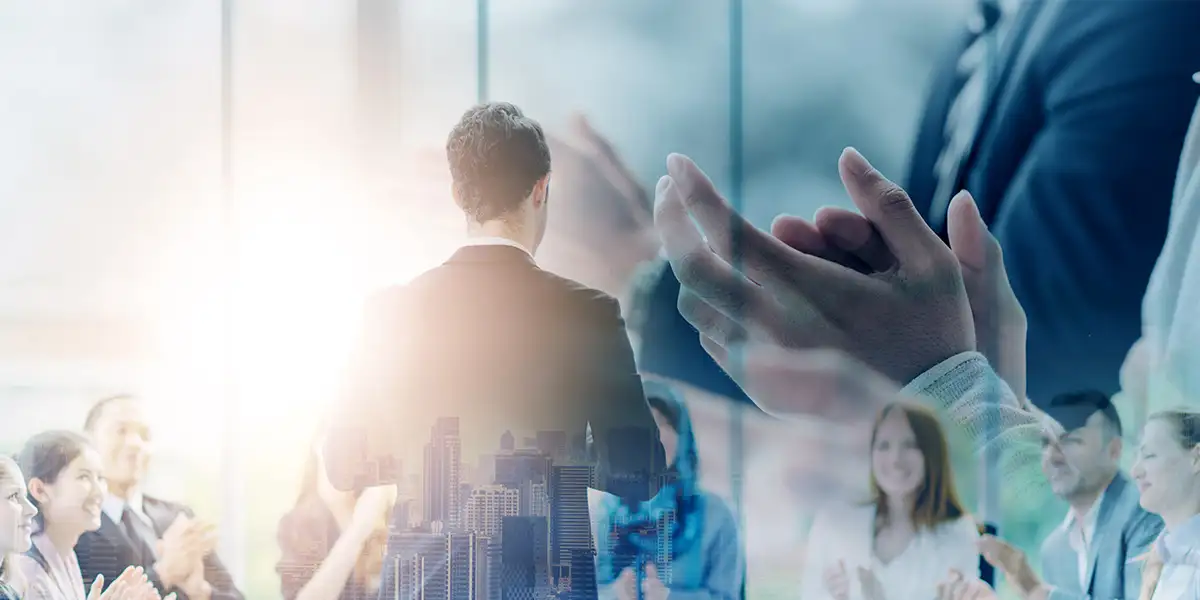 Digital composite image of business people clapping and office buildings