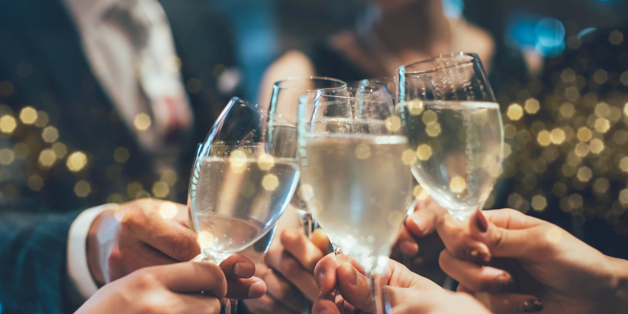 Group of people clinking champagne glasses in a celebratory toast