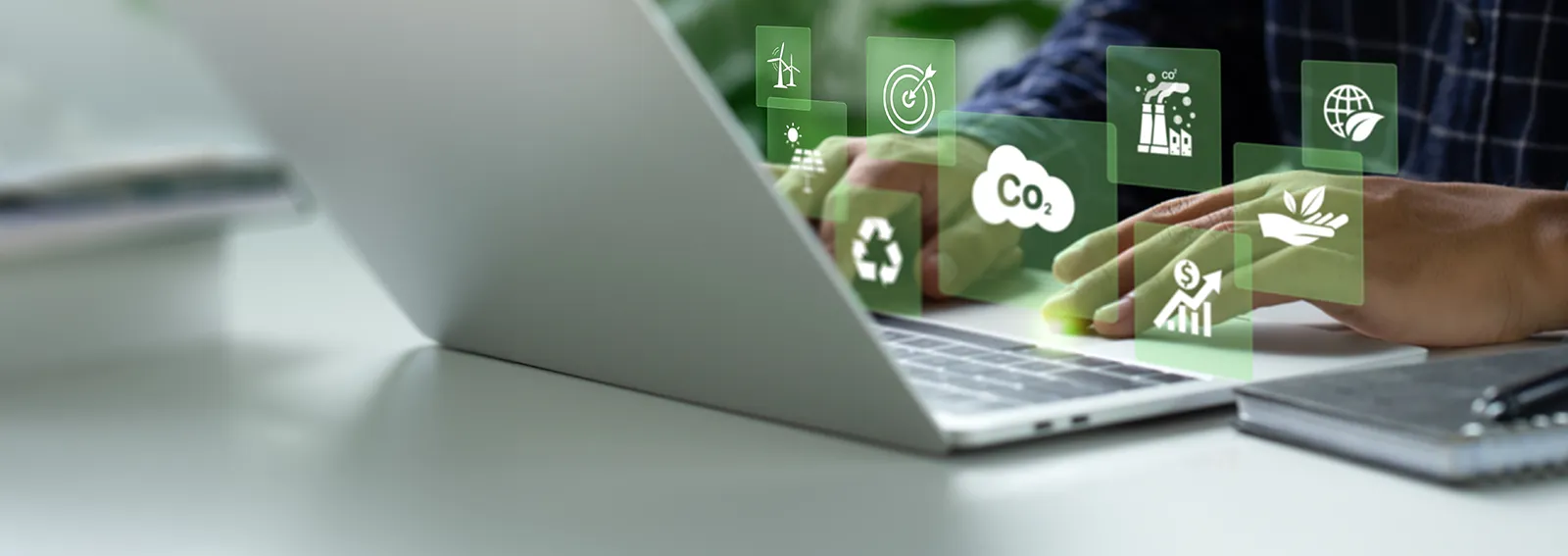 businessman working on a laptop with icons overlaid