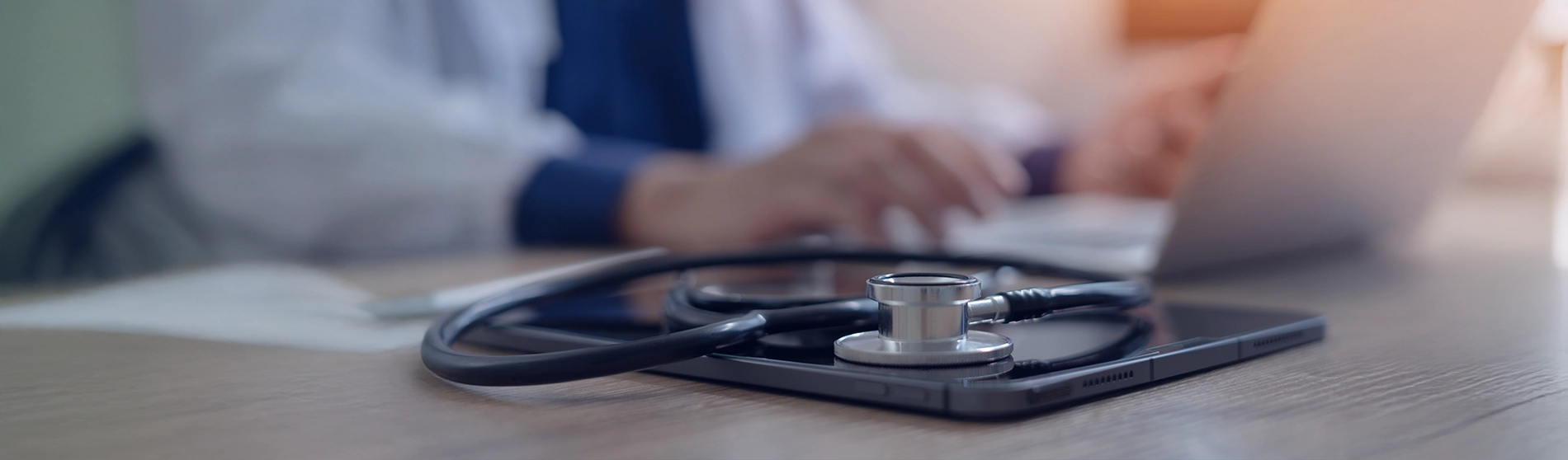 Stethoscope sitting on phone on desk
