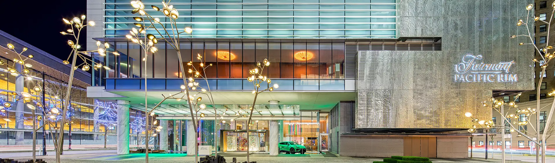 Front door of the Fairmont Pacific Rim Hotel at night.