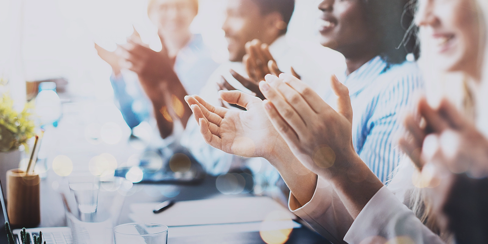 Photo of partners clapping hands after business seminar