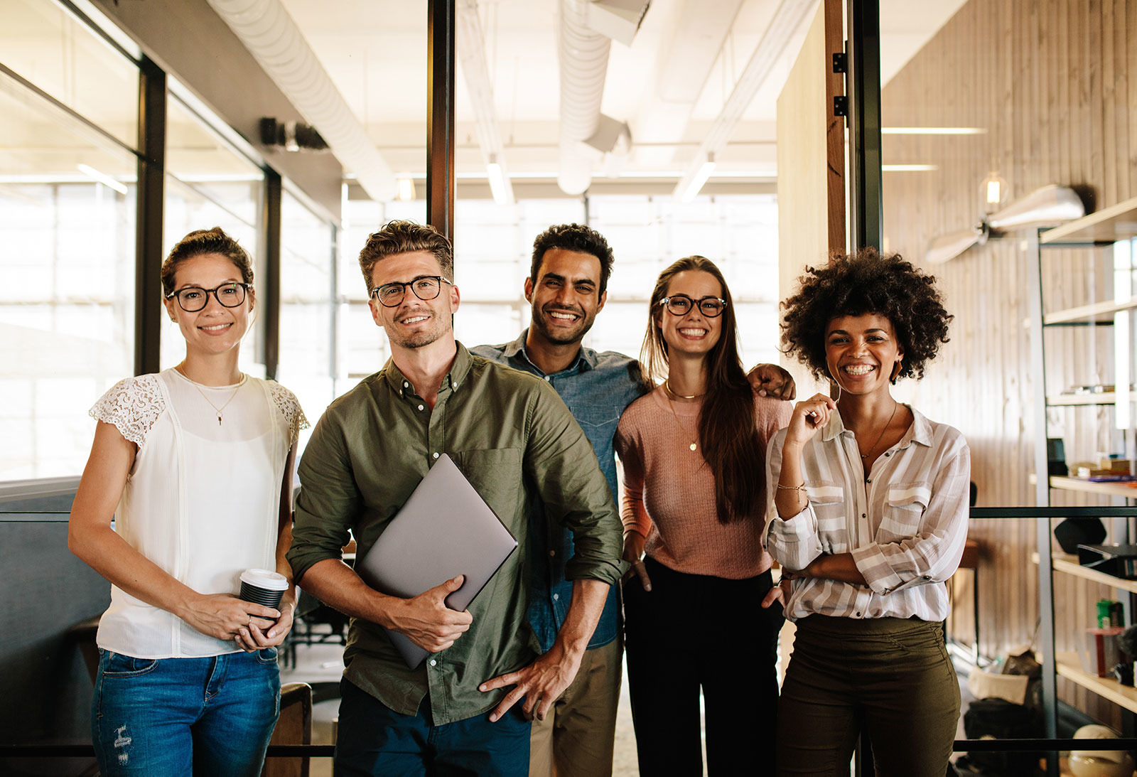 group of professionals smiling together in an office