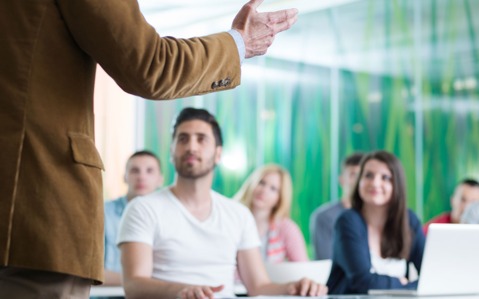 professor giving a lecture in a classroom setting