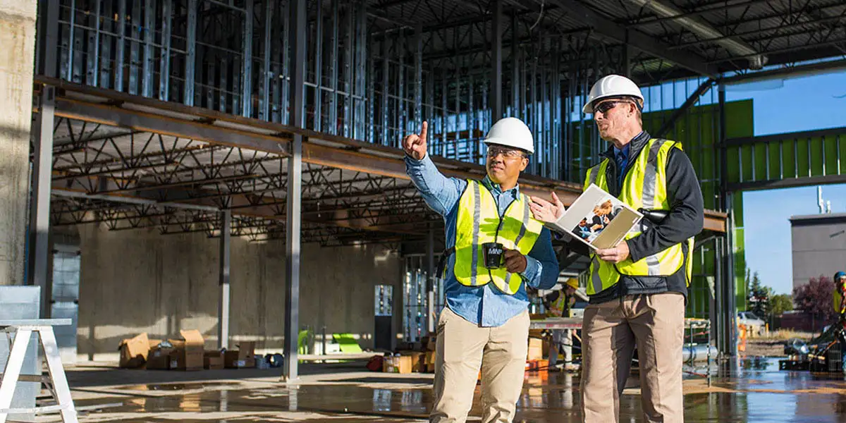 Two construction workers on site