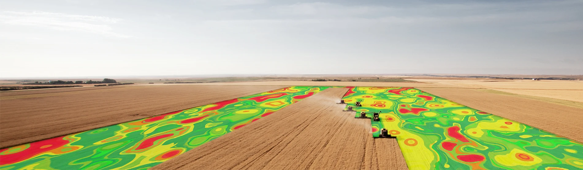 combines in a field with yeild mapping overlay