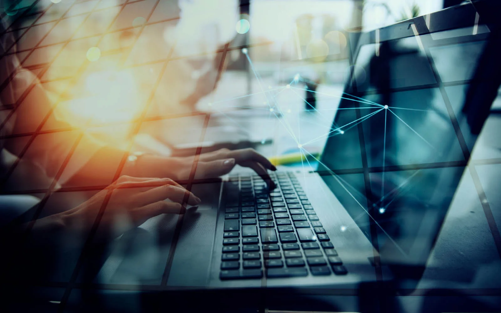 Business woman typing on a laptop with an overlay of digital data