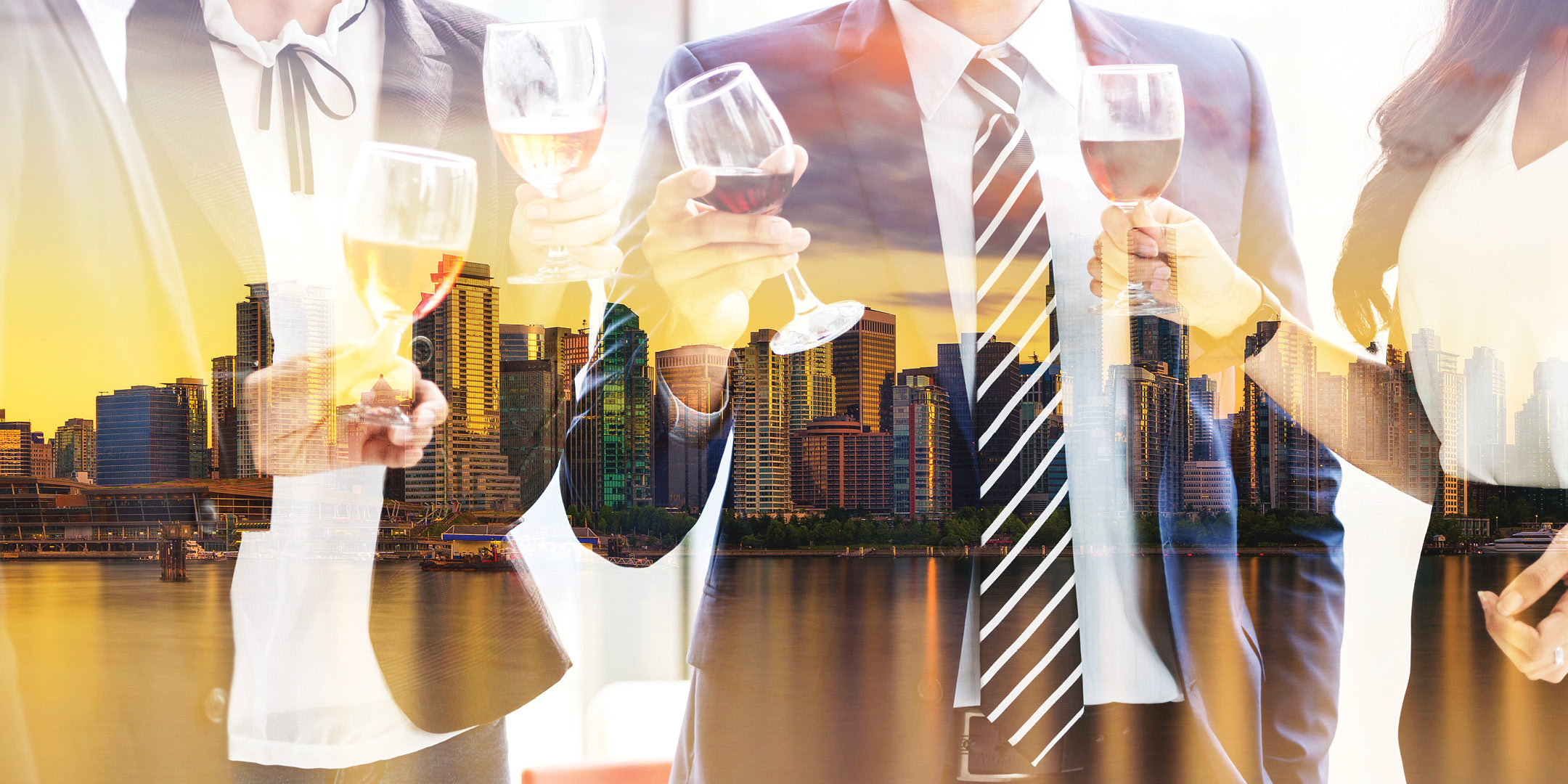 Business people celebrating with wine with a transparent photo of a city skyline in the background.
