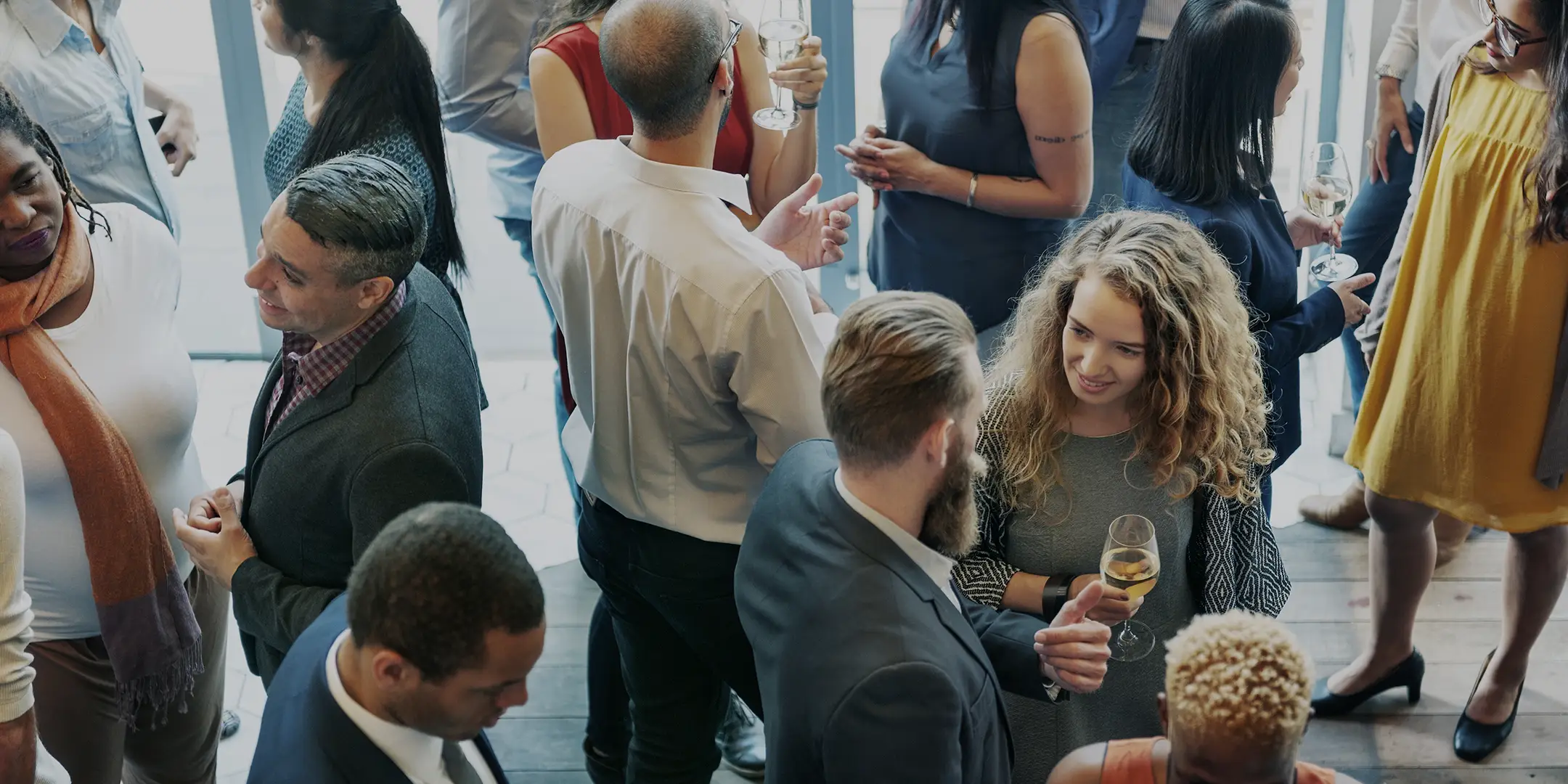 A group of professionals networking at a corporate party.