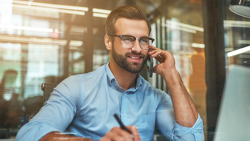 A businessman talking on his cellphone in the office
