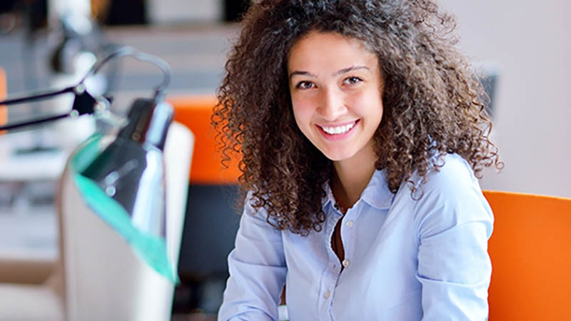 Une femme d'affaires souriant au bureau