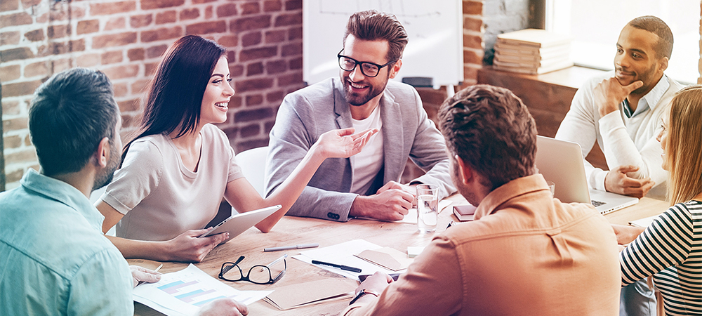 people in a meeting around a table