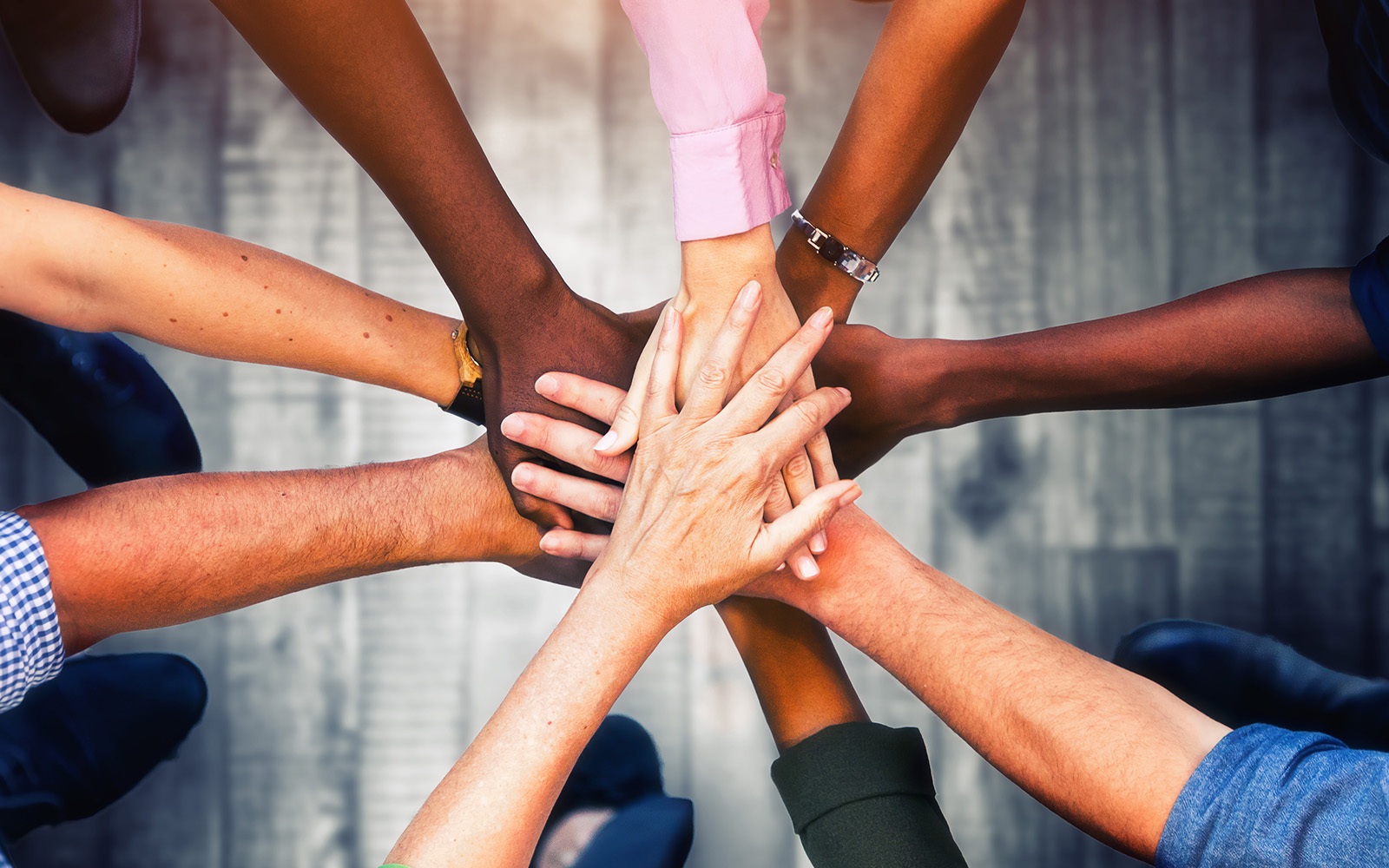 Group of people's hands joining in unity