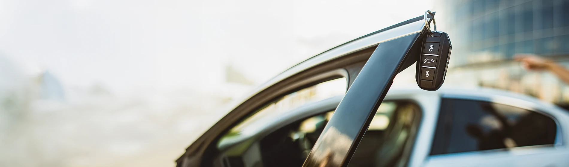 close up of a key hanging on a car door