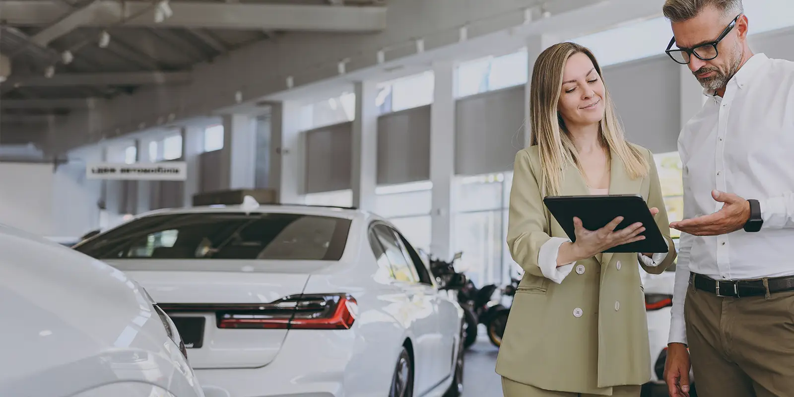 Customer consult with salesperson at a car dealership