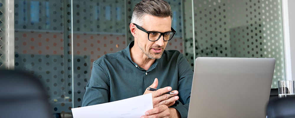 Businessman sitting at desk looking at computer