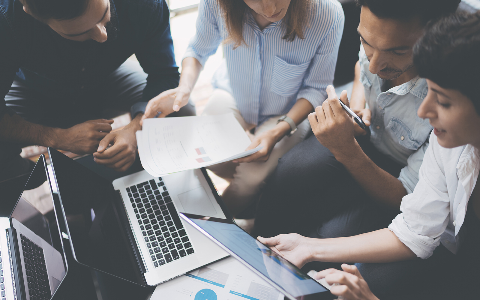 group of people reviewing papers