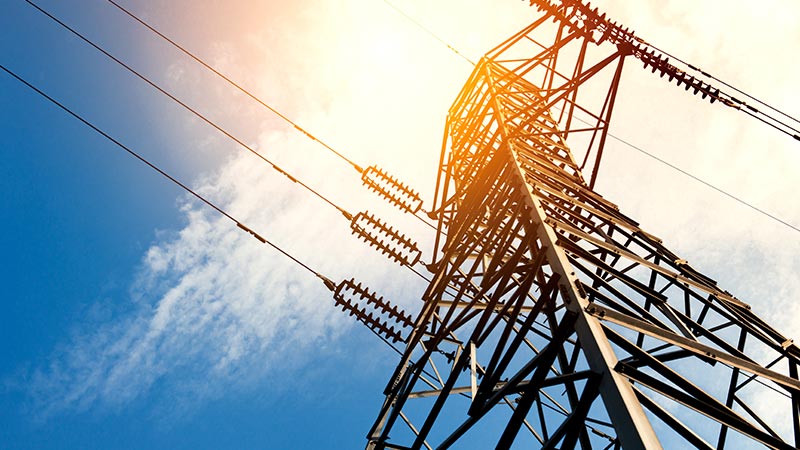 Ground view looking up at an electricity tower