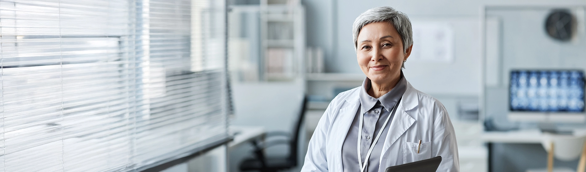 smiling mature female doctor in her office