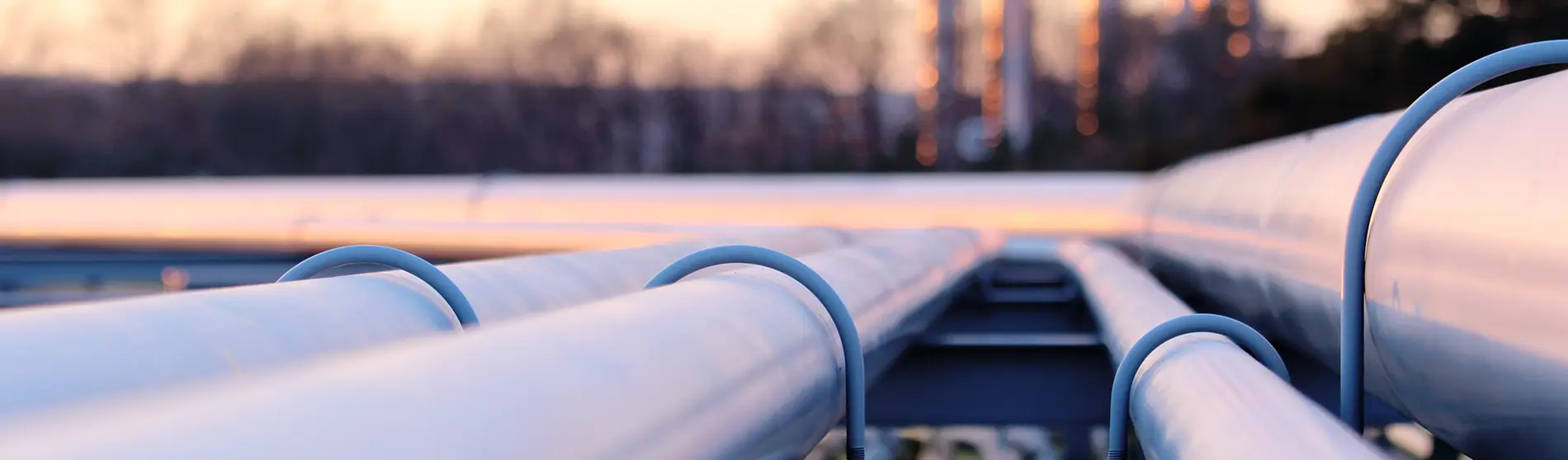 steel long pipes in crude oil factory during sunset