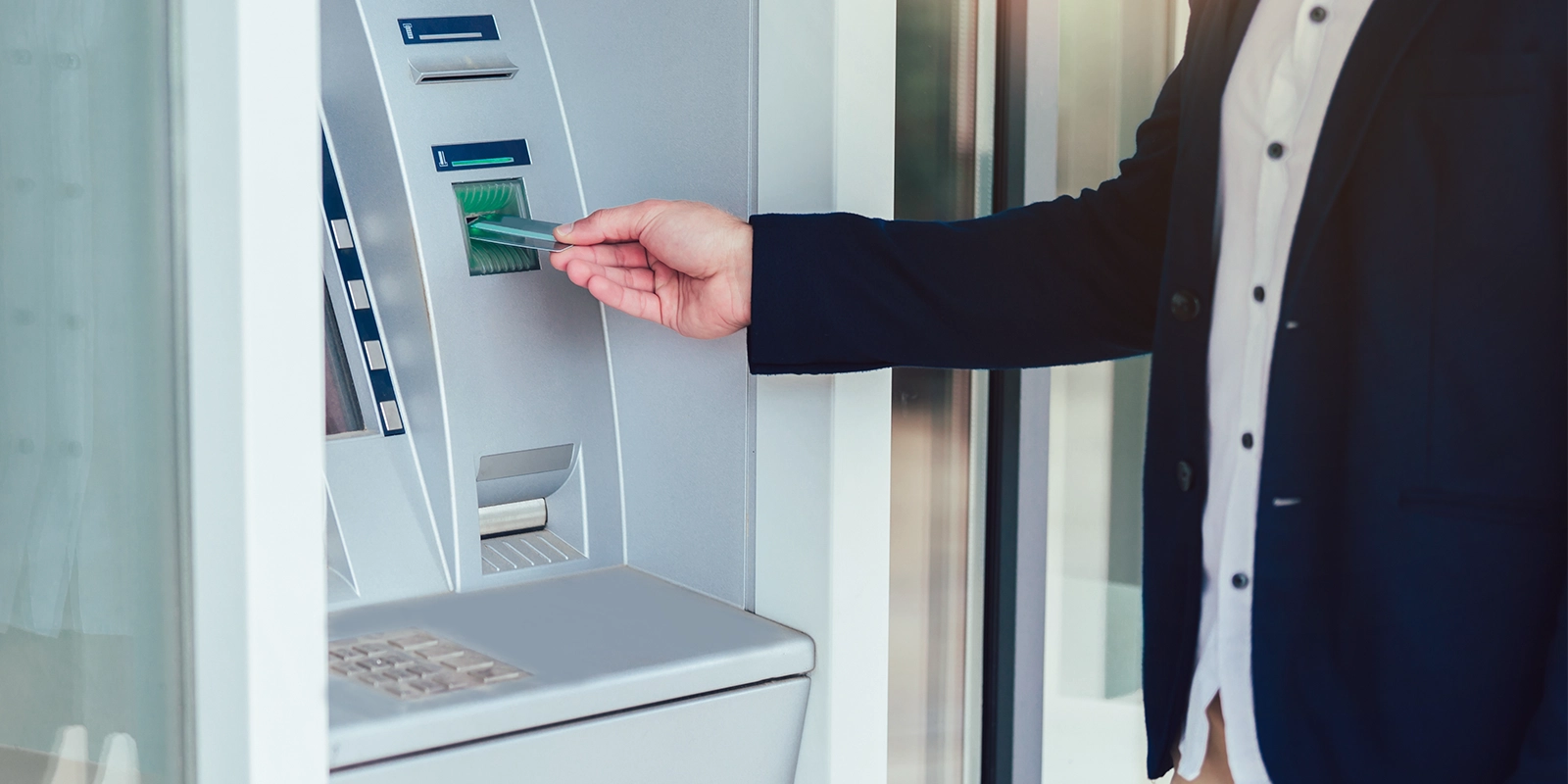 Business man using ATM