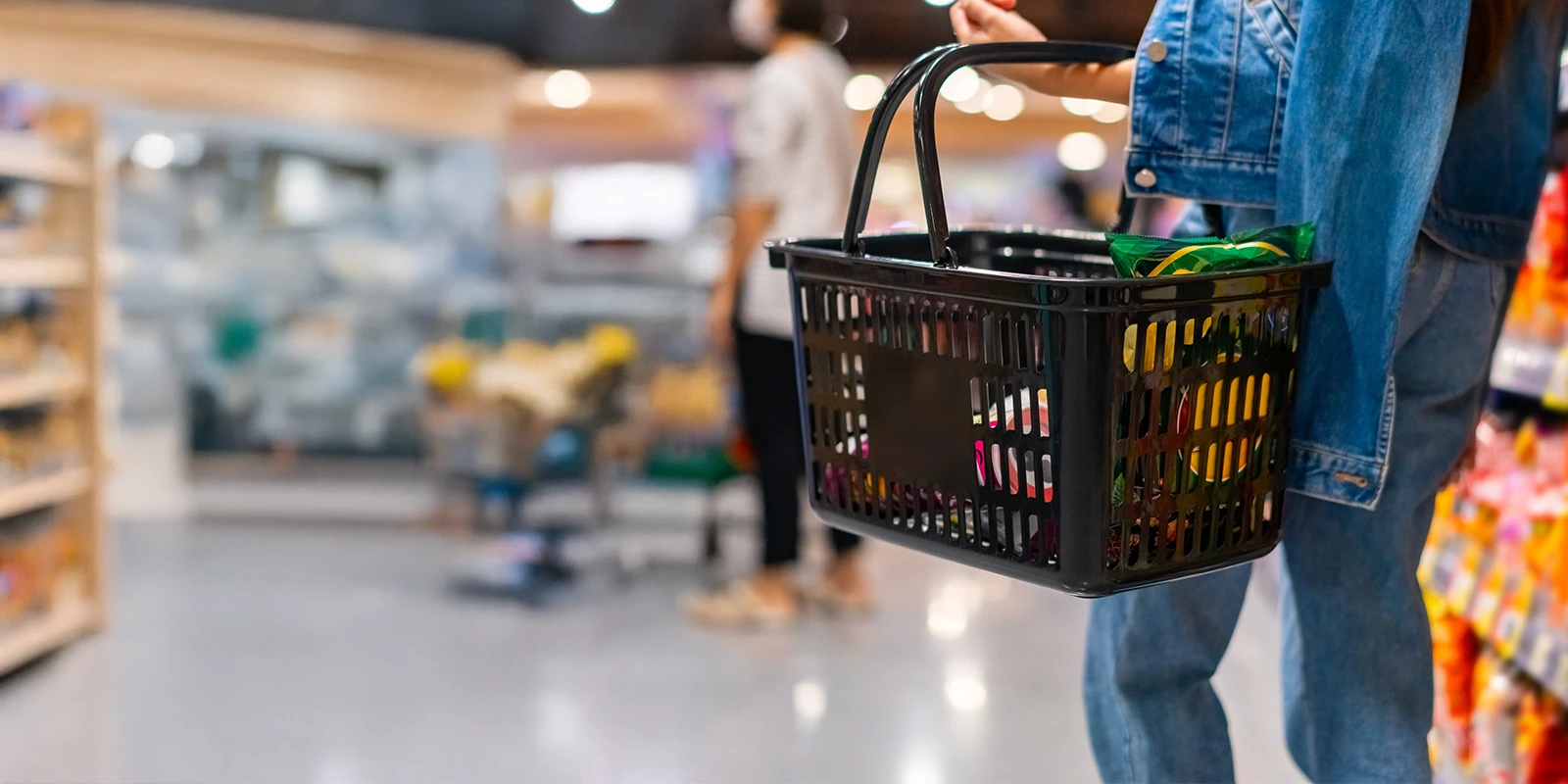 woman shopping holding a grocery basket